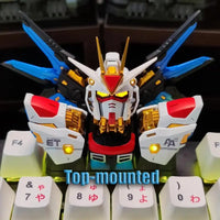 Close-up of Strike Freedom Gundam emblem on artisan keycap for keyboard customization